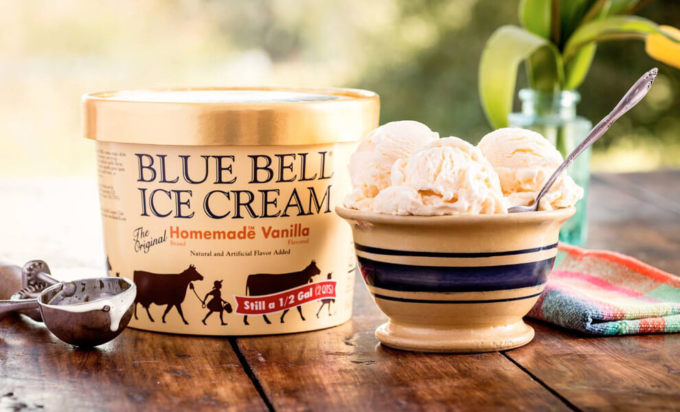 Blue Bell Homemade Vanilla ice cream in gallon and scoops in a bowl