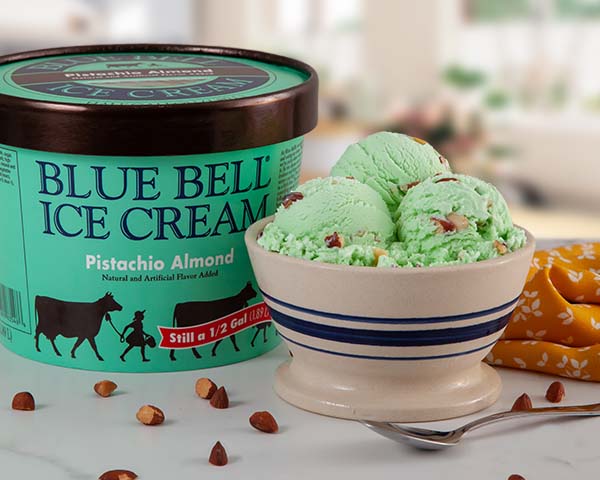 Blue Bell Pistachio Almond Ice Cream in bowl with carton in sunny kitchen