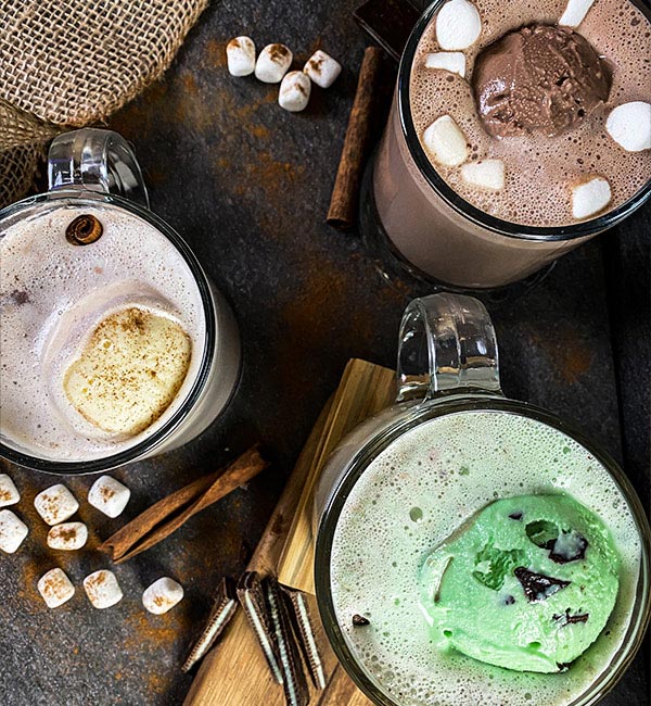 Overhead view of three different flavors of Blue Bell hot chocolate recipes