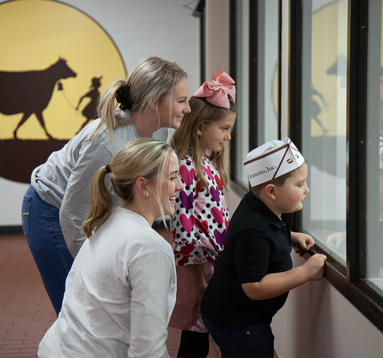 Children with tour guides looking thru windows of observation deck