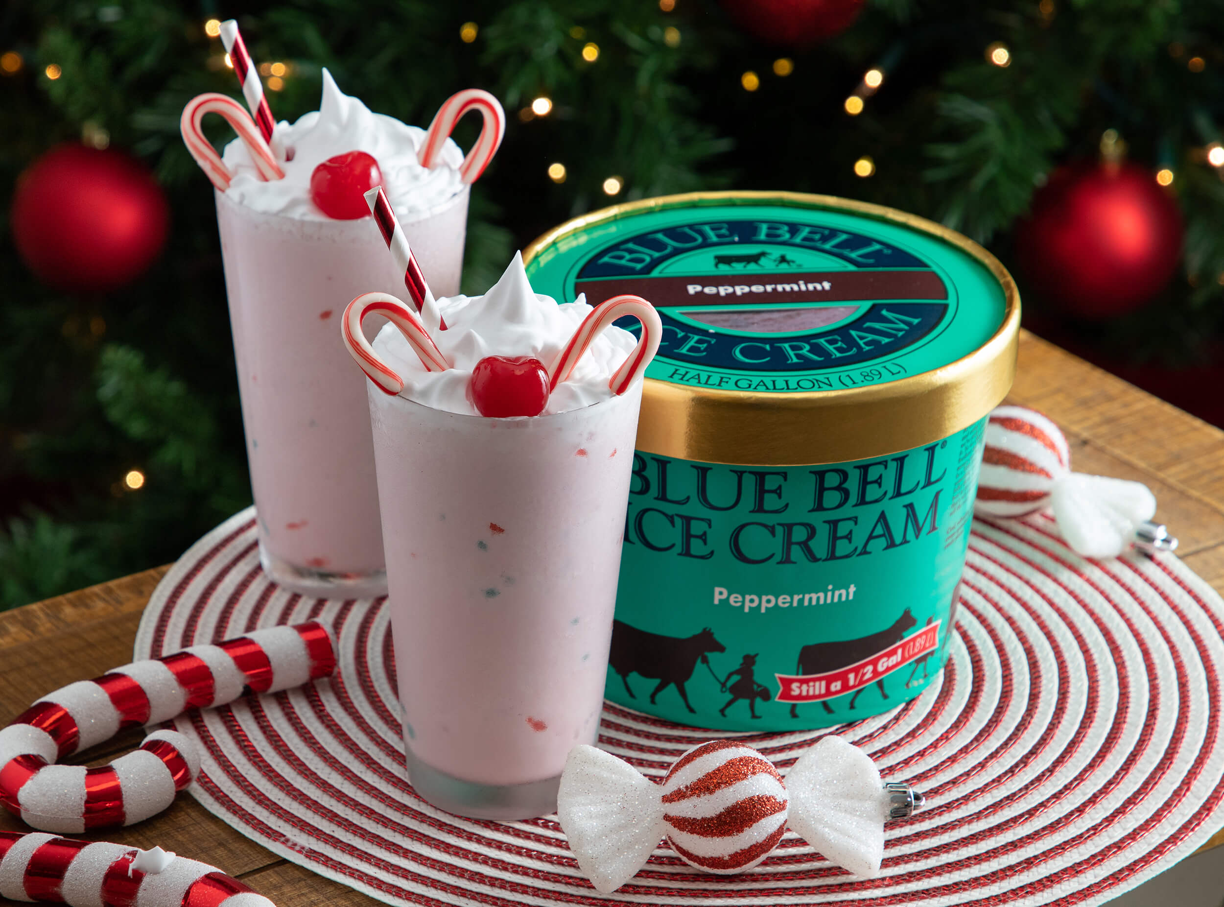 Blue Bell Peppermint Ice Cream Reindeer Milkshakes garnished with cherries and candy canes.