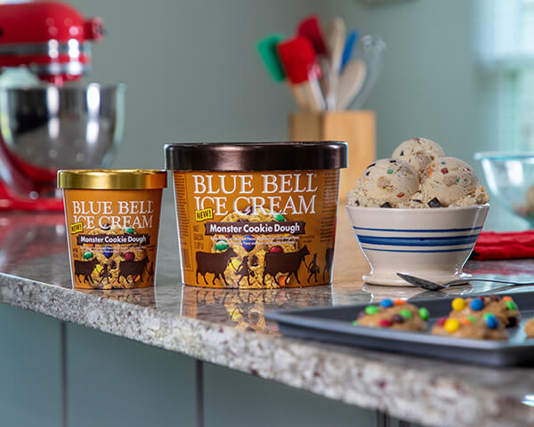 Blue Bell Monster Cookie Dough Ice Cream in half gallon and pint displayed on kitchen counter