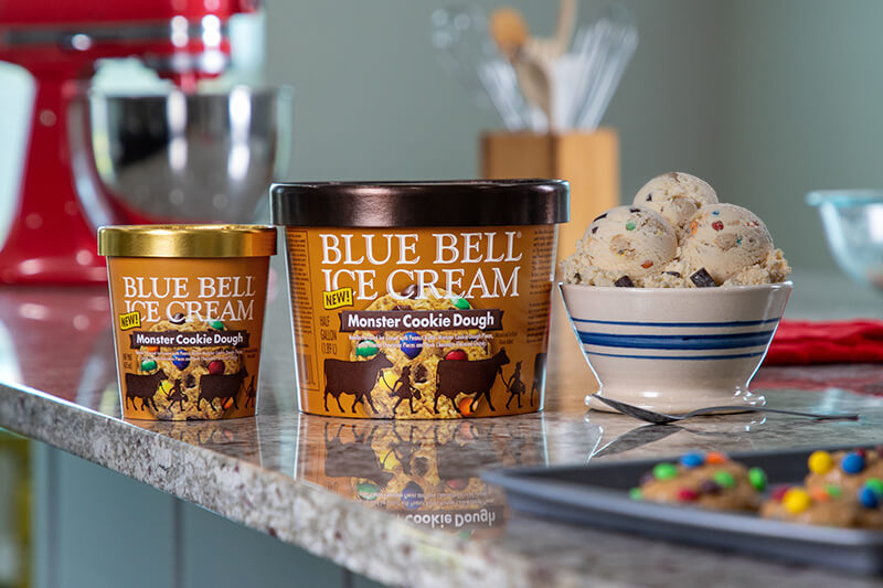 Blue Bell Monster Cookie Dough Ice Cream in half gallon and pint displayed on kitchen counter